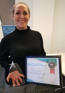 Nikki Holdsworth holds award